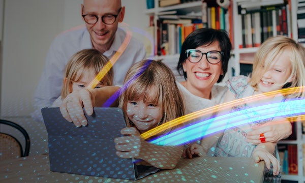 Happy young family making video call with tablet at home