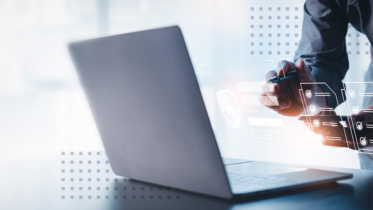 Close up view of businessman hand, holding a pen over virtual documentation graphic in bright modern office room